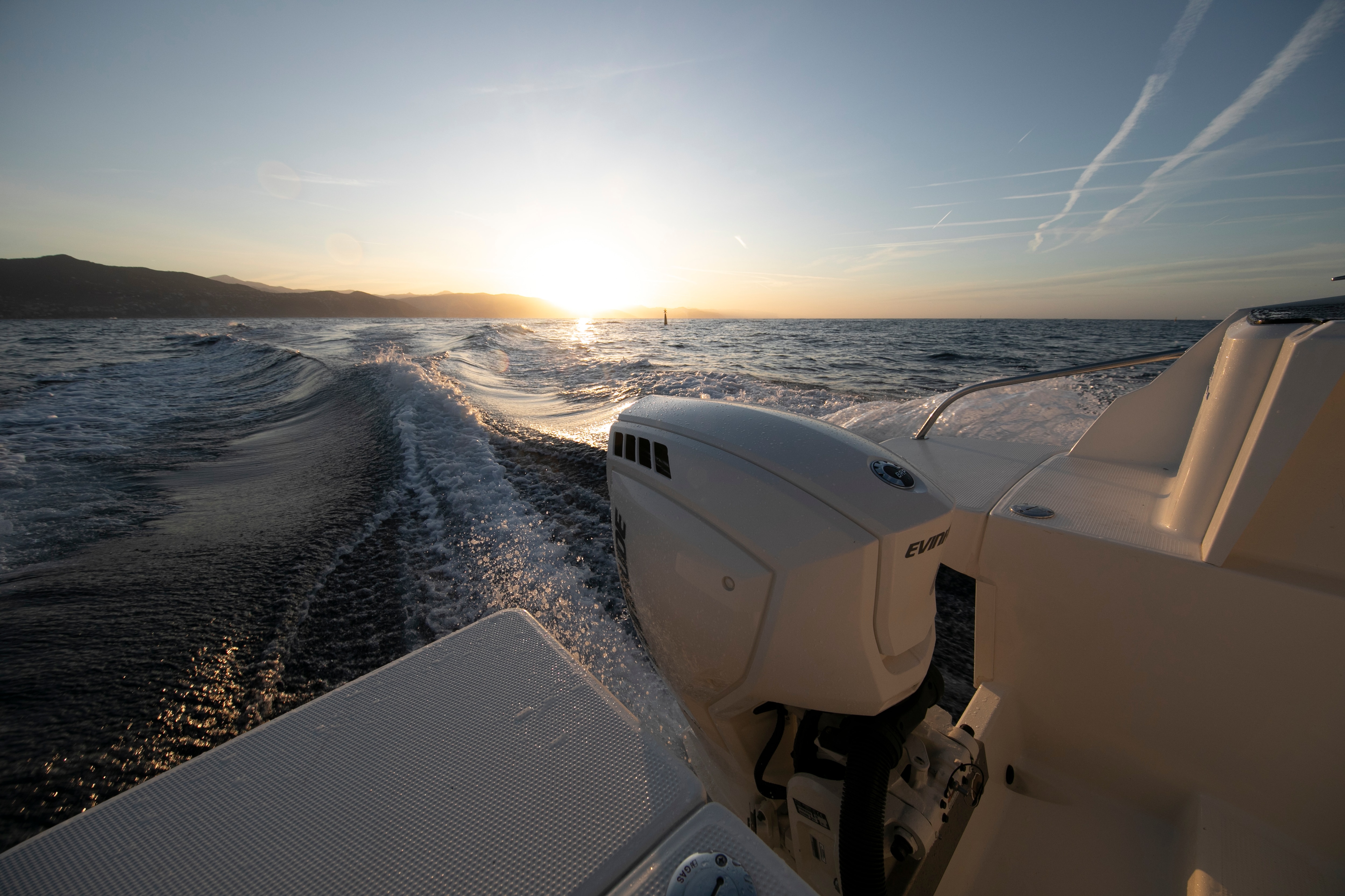 Evinrude motor with a sunset in the background