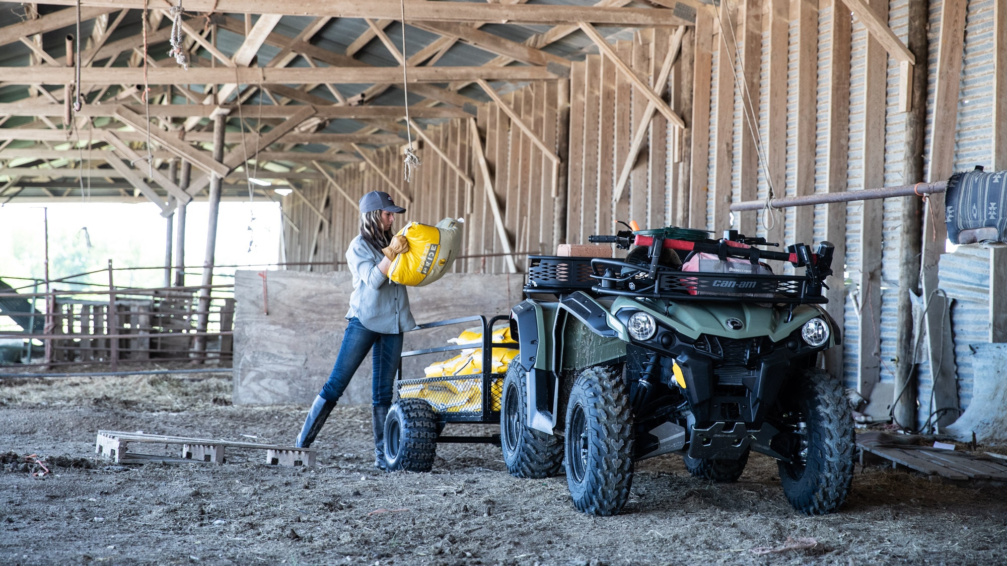 Woman carrying heavy materials on the trailer of her Outlander 450/570