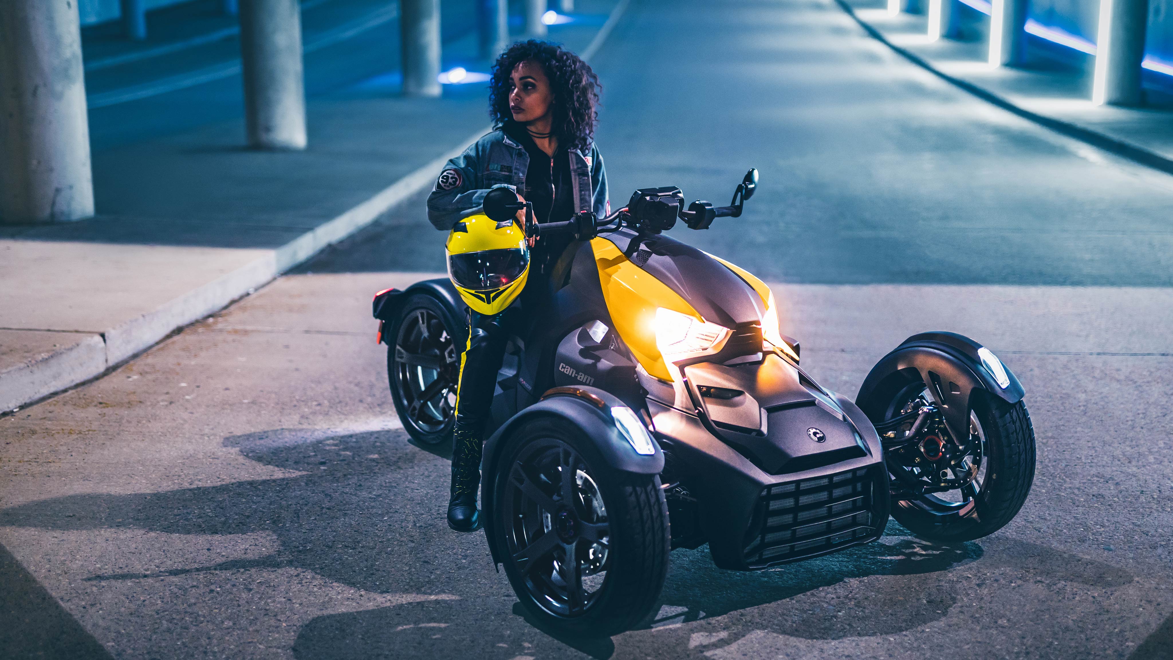 Woman sitting her Can-Am Ryker at night