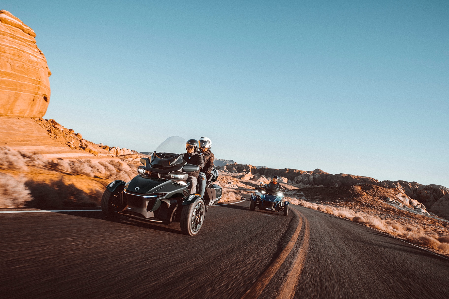 A couple ride their Spyder RT on the road