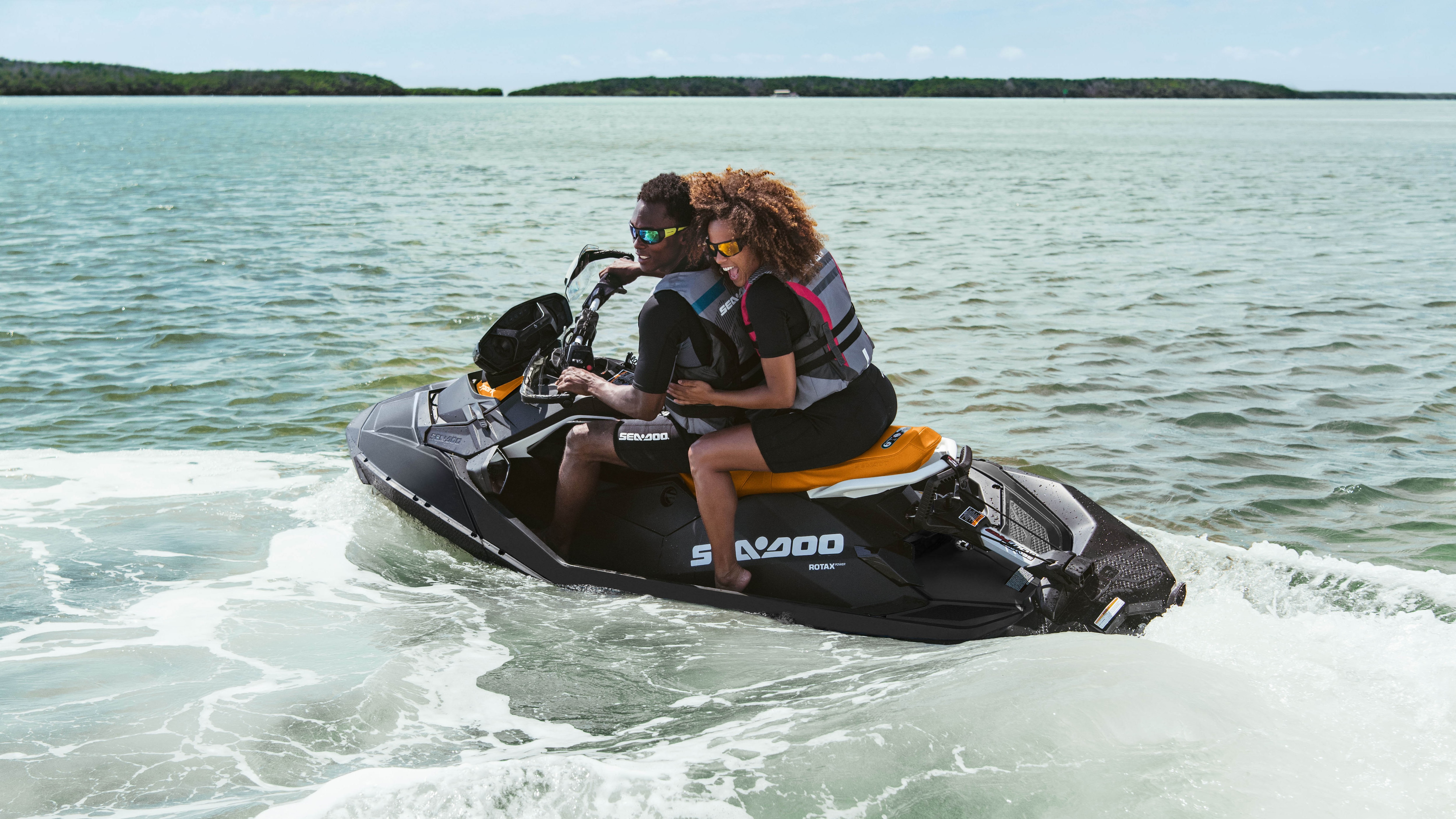 A couple riding their Sea-Doo Spark in the water