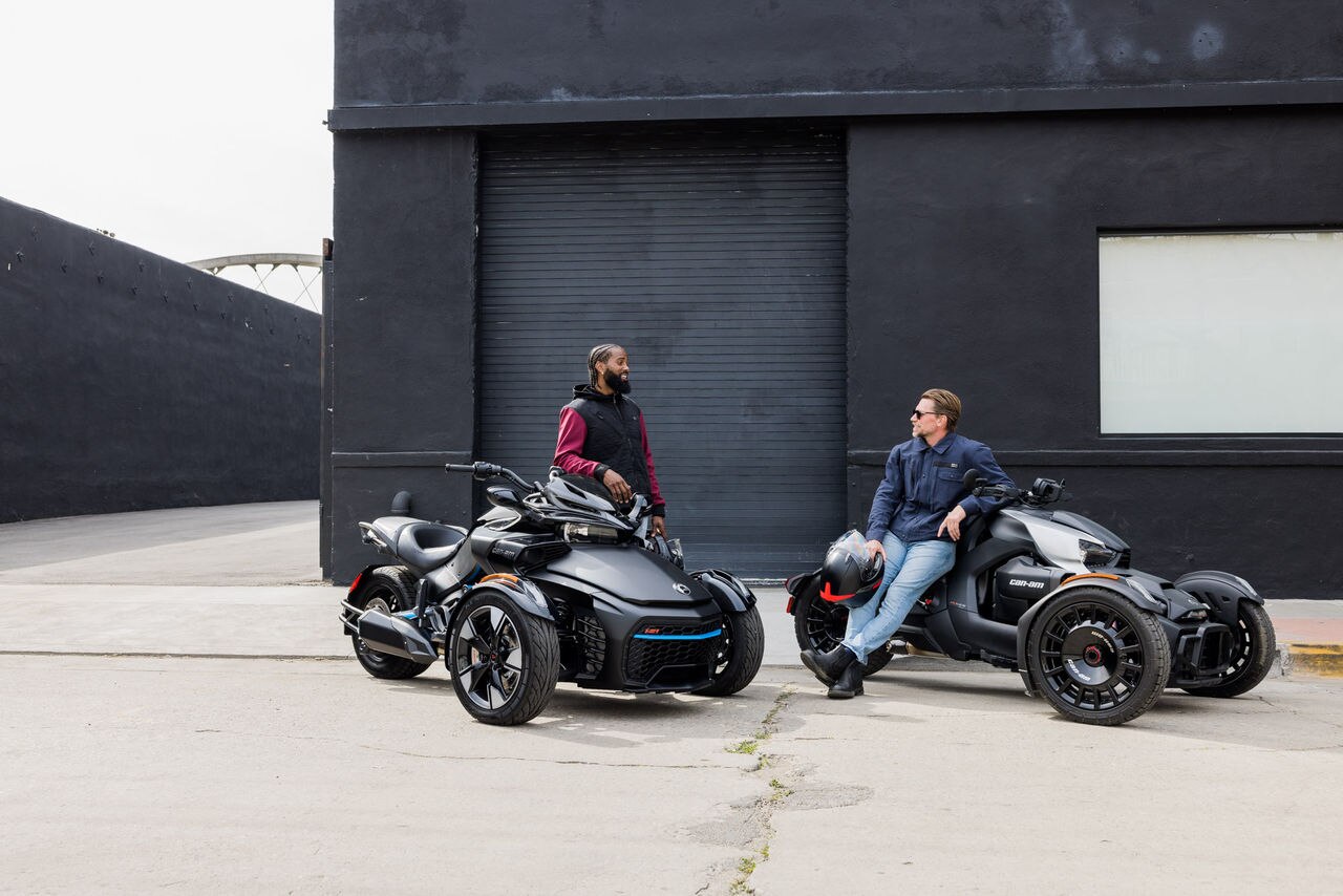 Riders discussing next to their 3-wheel vehicles