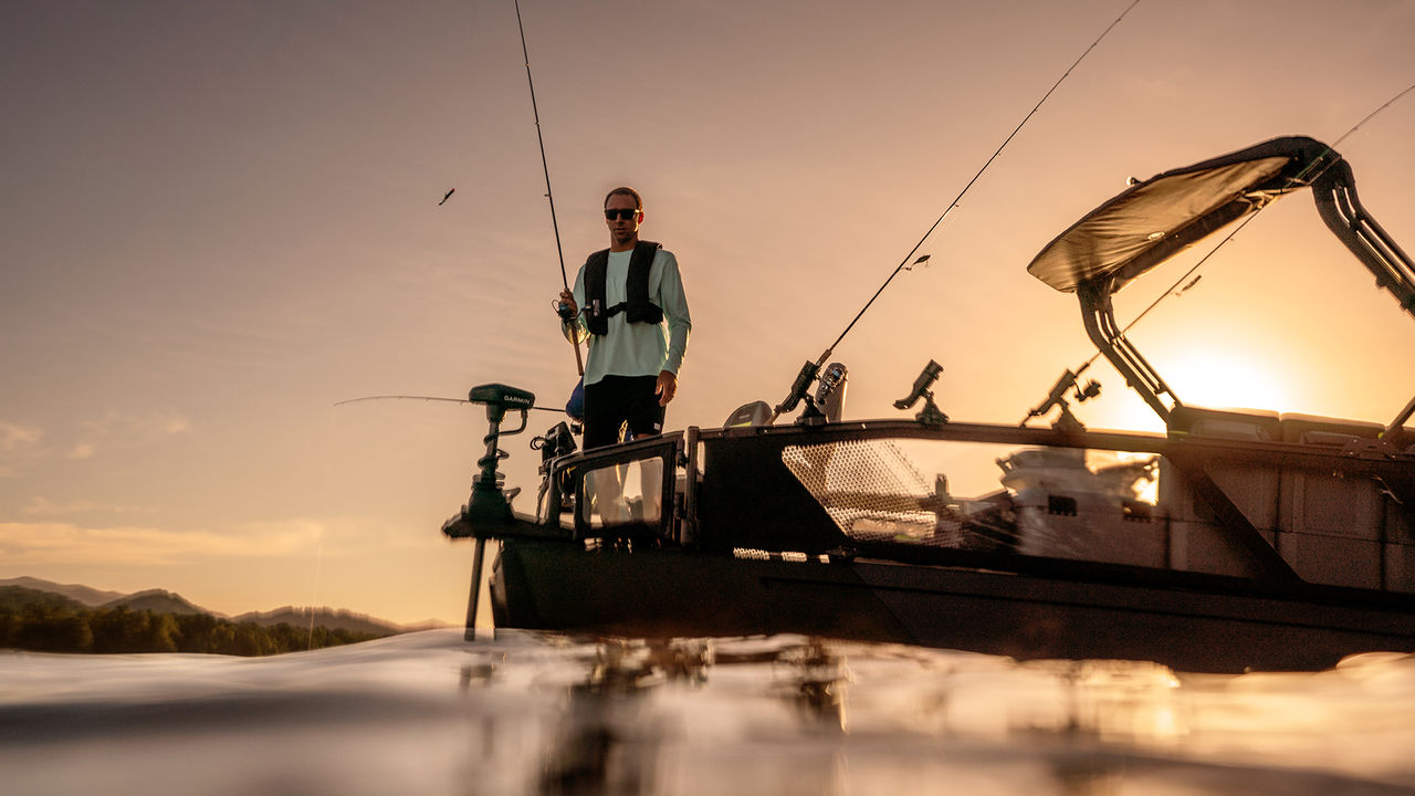 A fisherman on a 2026 Sea-Doo Switch Fish at sunset