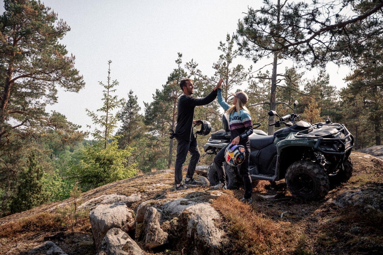 A couple next to an Outlander Max Pro XU HD7 in the mountains