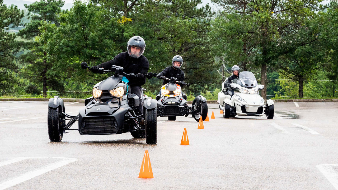 Several people taking their Can-Am 3-wheel motorcycle driving test