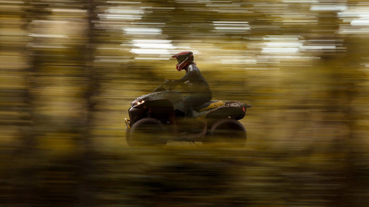 A Can-Am Renegade with blurred surroundings