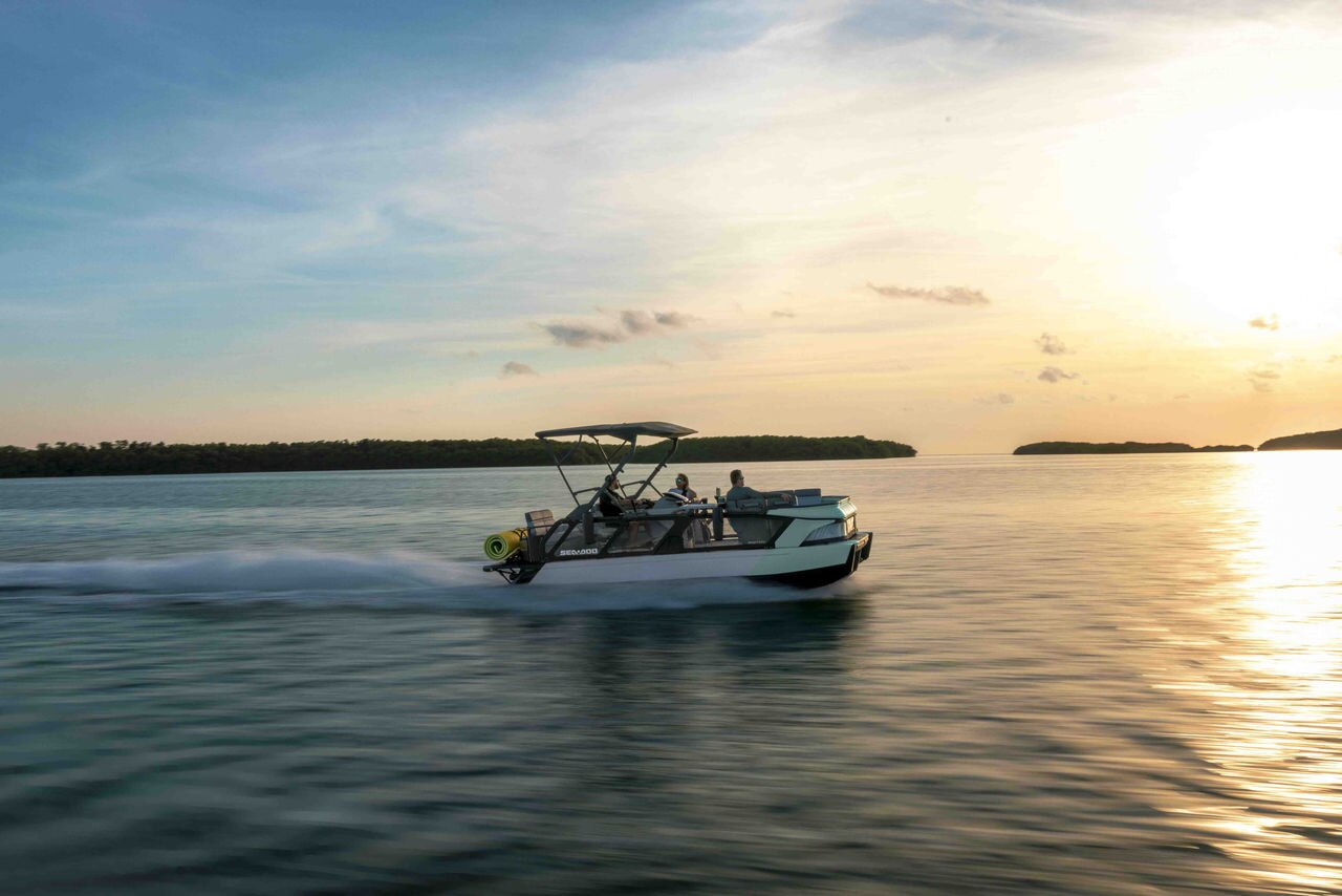 A group of friends on a 2026 Sea-Doo Switch Cruise on a calm lake