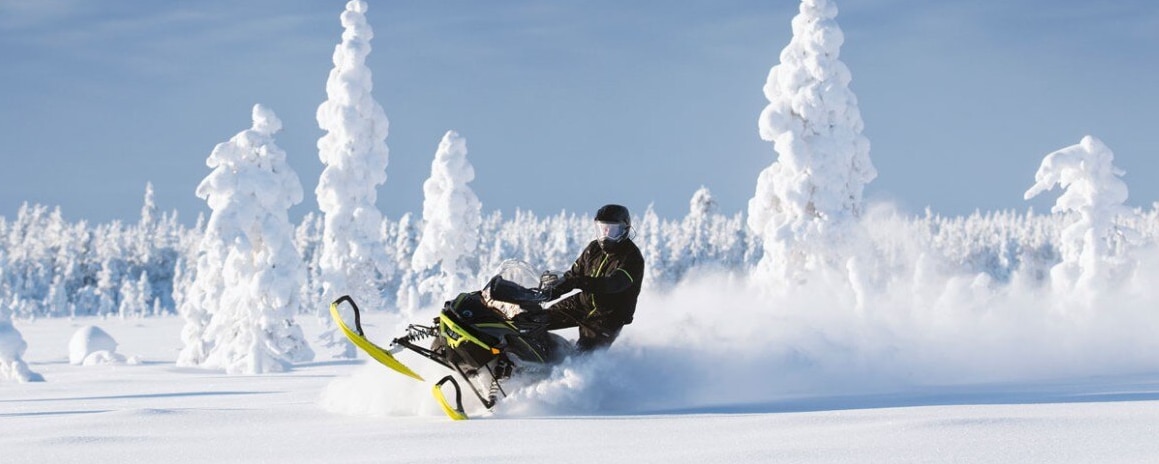 Man riding a Lynx snowmobile