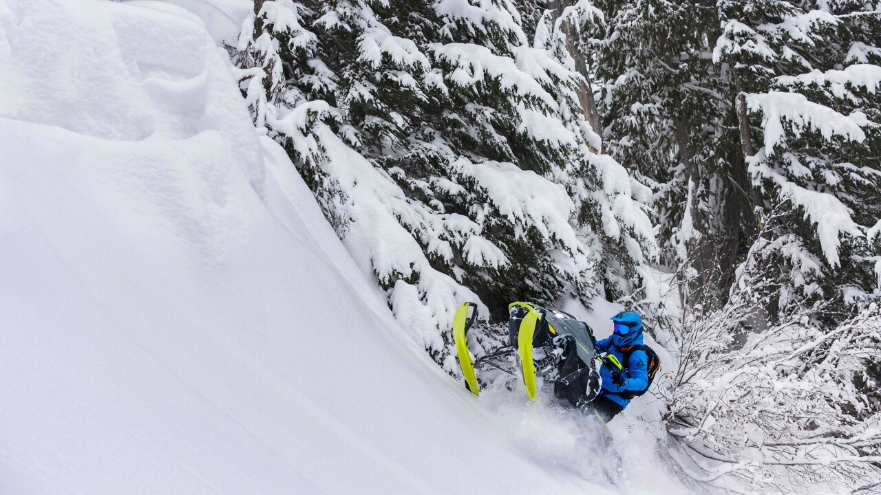 Man riding in deep-snow with the new 2023 Ski-Doo Summit