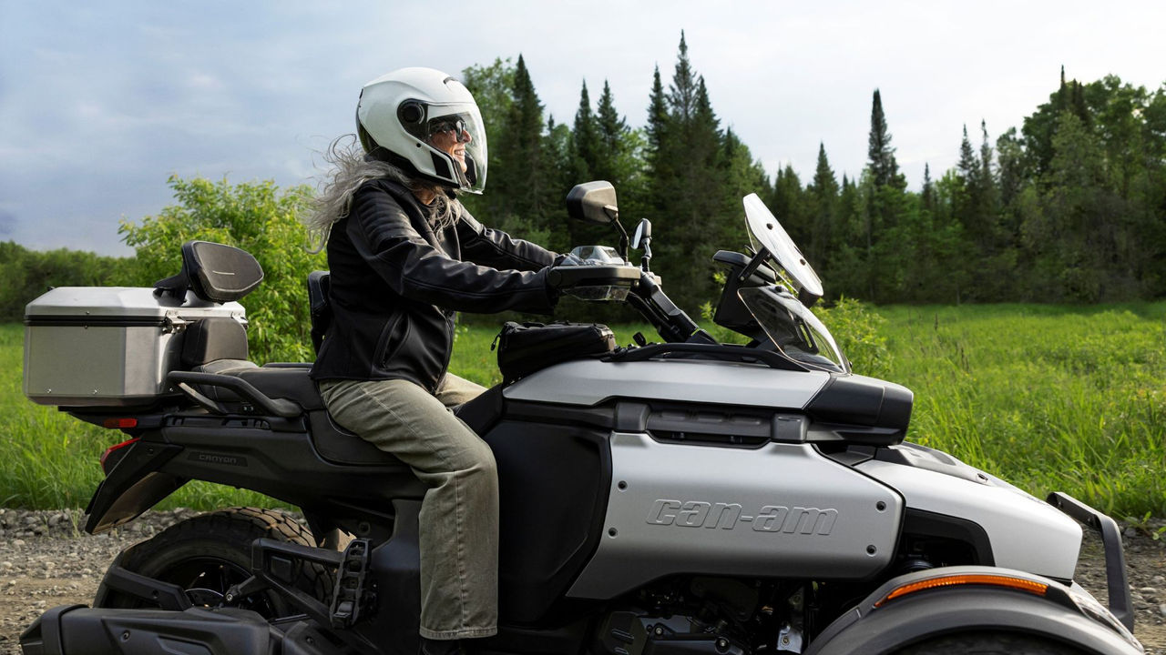 A woman riding a 2026 Can-Am Canyon