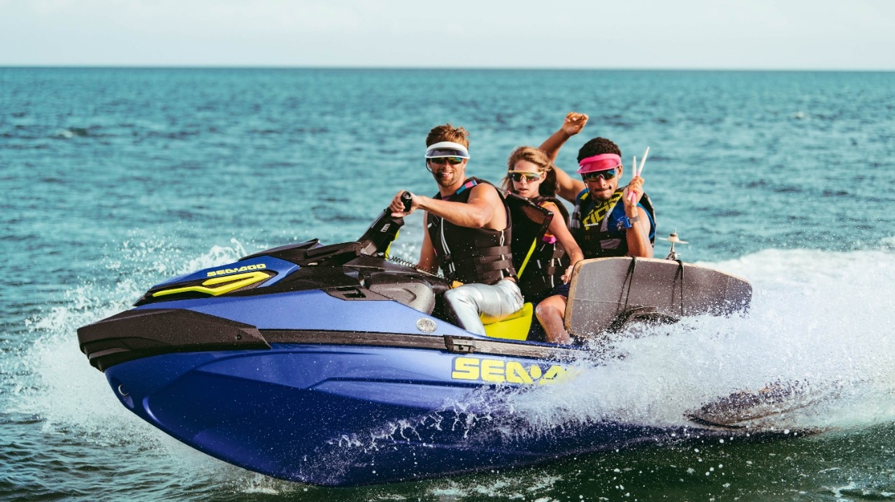 Group of three riding a Sea-Doo Wake Pro 230