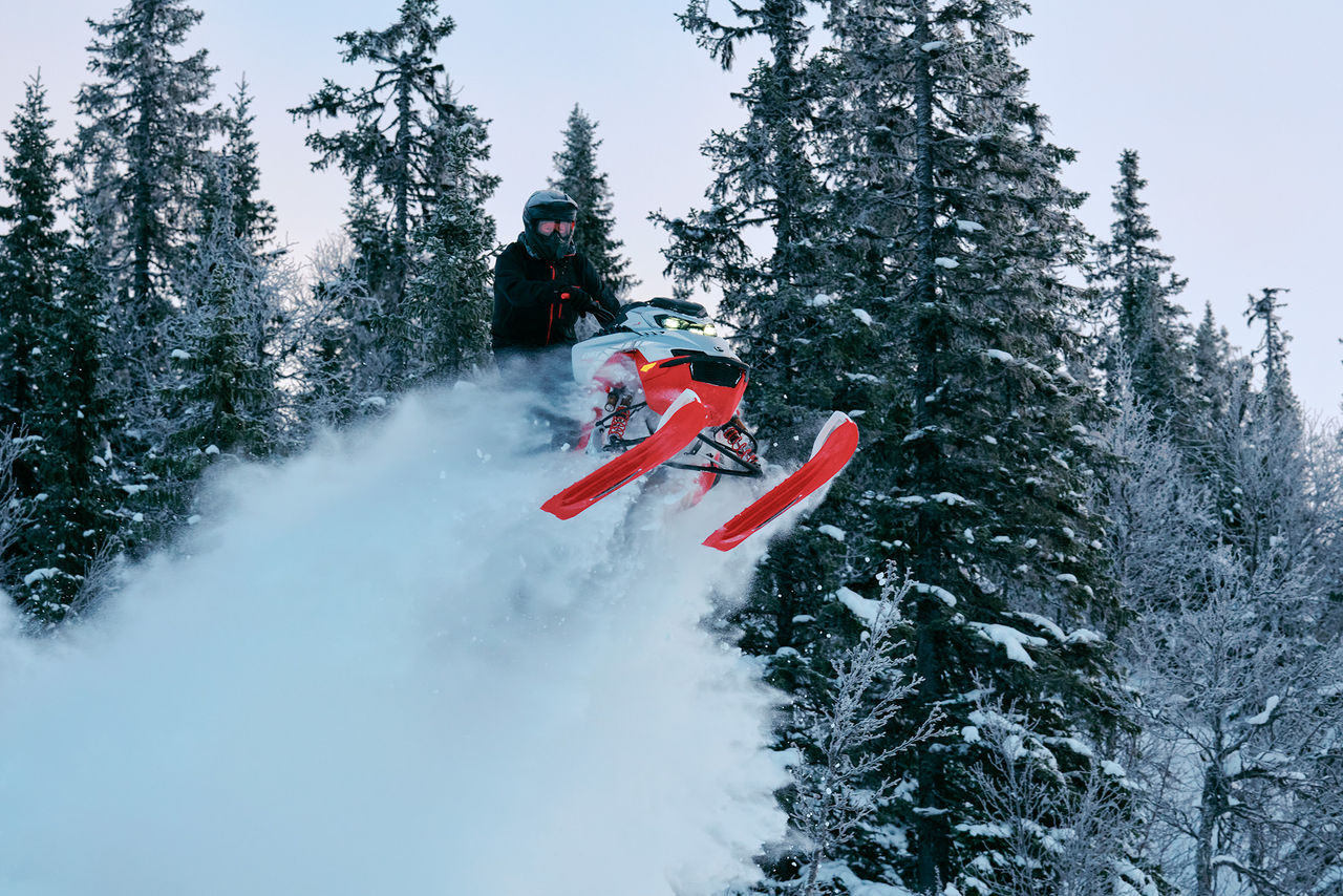 Rider in mid-air on a 2027 Lynx Shredder RE snowmoile