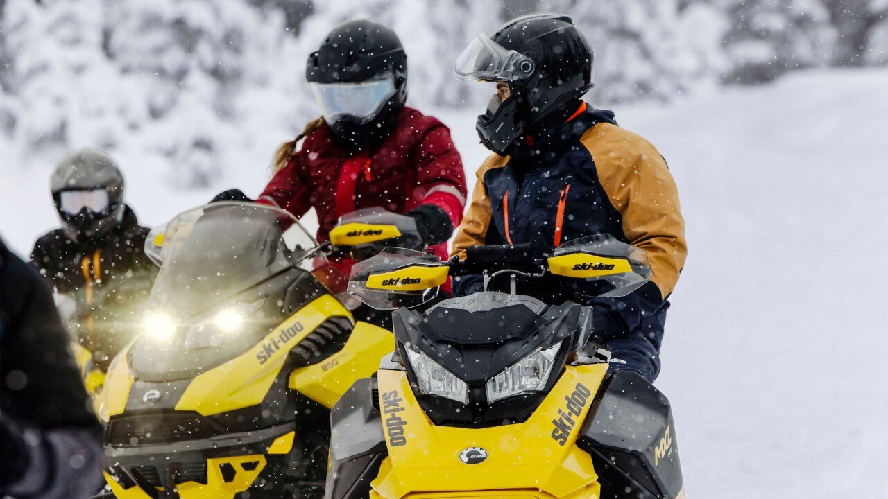 Family with the 2023 Ski-Doo MXZ snowmobiles