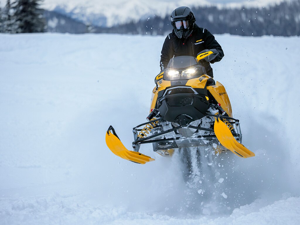 Rider performing a jump with a 2027 Ski-Doo Backcountry X-RS snowmobile