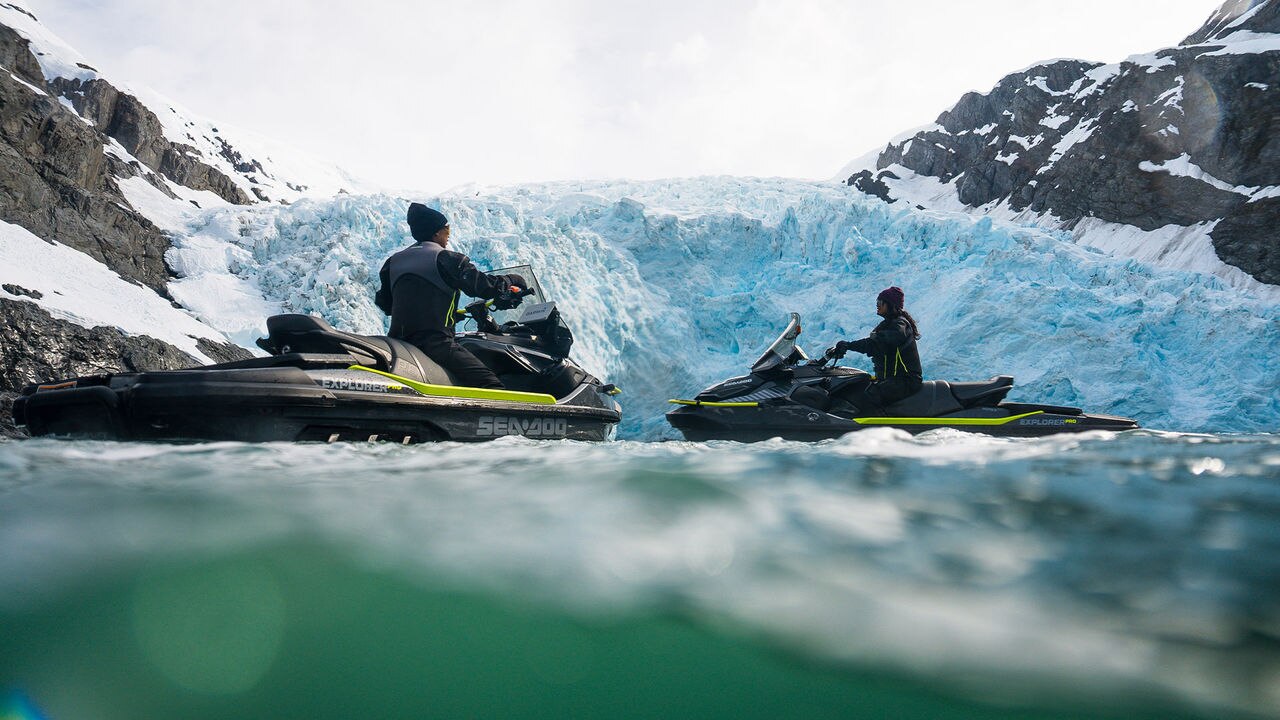 Two Sea-Doo personal watercrafts idle on the water