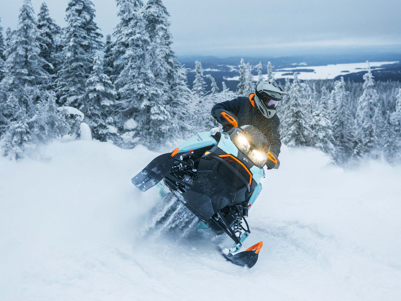 group of people riding Ski-Doo snowmobiles