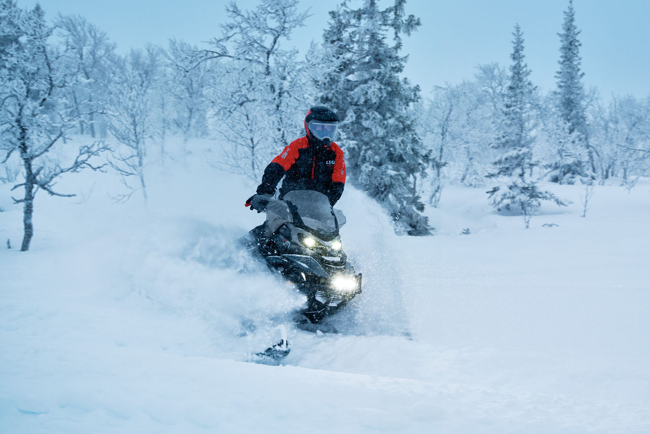 2027 Lynx Commander RE snowmobile riding in deep snow