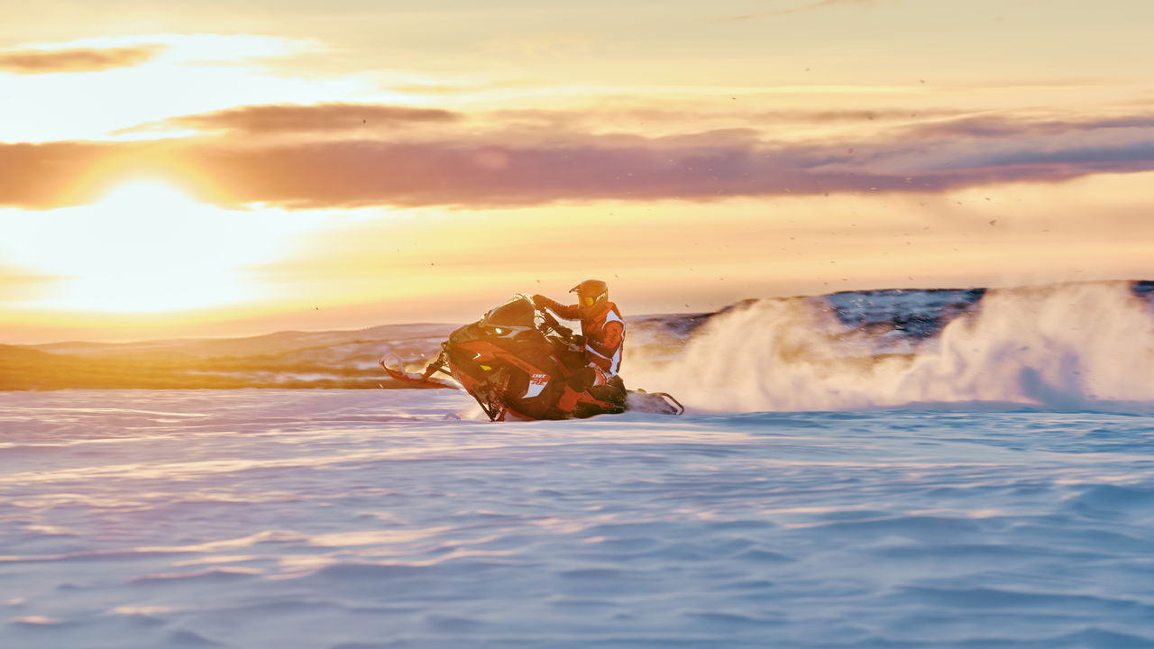 Lynx Rave RE 850 Turbo R 2026 snowmobile riding on a bumpy trail