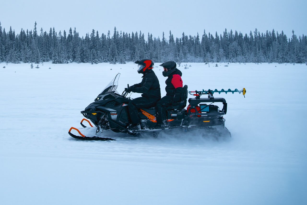 Two riding on a 2027 Lynx 59 Ranger PRO on a snowfield