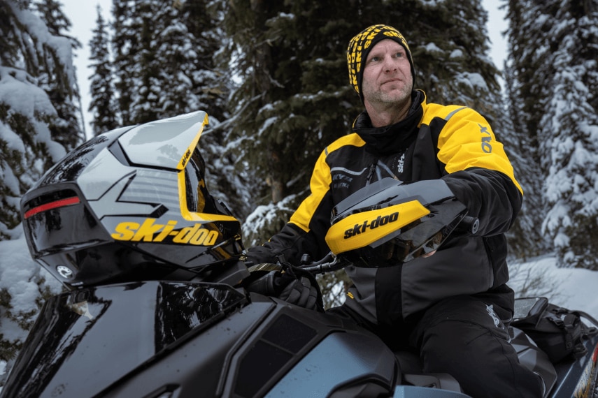 Man riding a Ski-Doo snowmobile