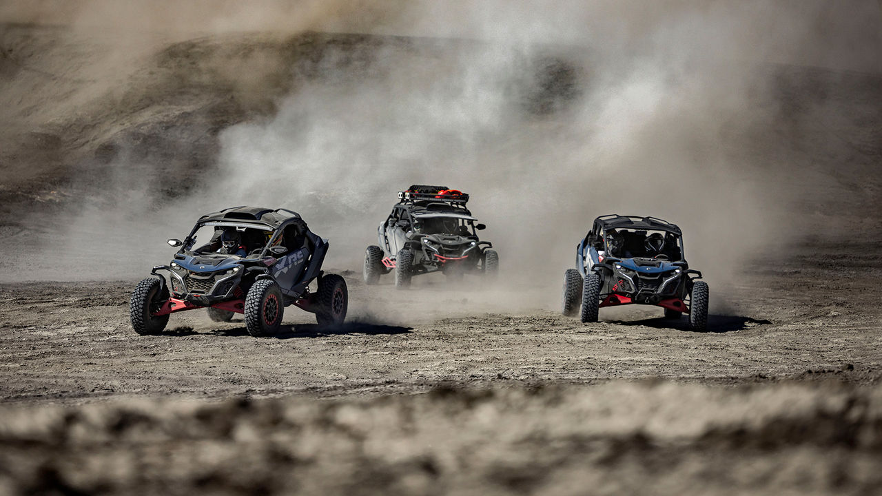 Man driving a Can-Am Maverick R in the sand