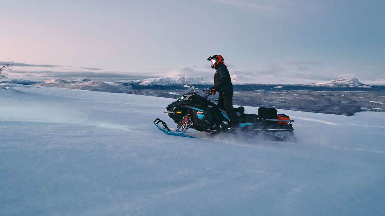 2026 Lynx Commander RE snowmobile riding uphill 