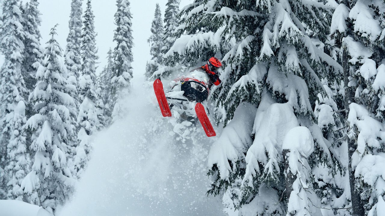 Lynx Shredder RE snowmobile lifting skis at mountains