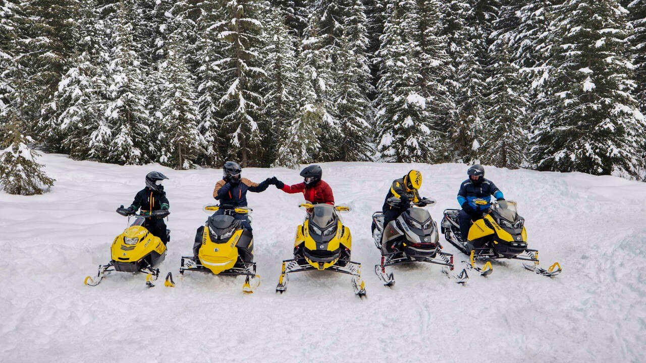 Family riding with their Ski-Doo trail sleds