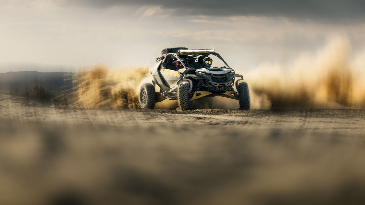 A Can-Am Maverick R SxS vehicle on a dirt trail