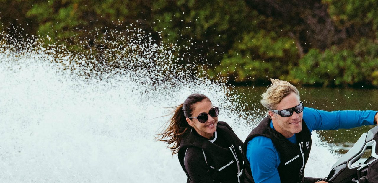Two women doing karate while standing up on a Sea-Doo GTX Limited