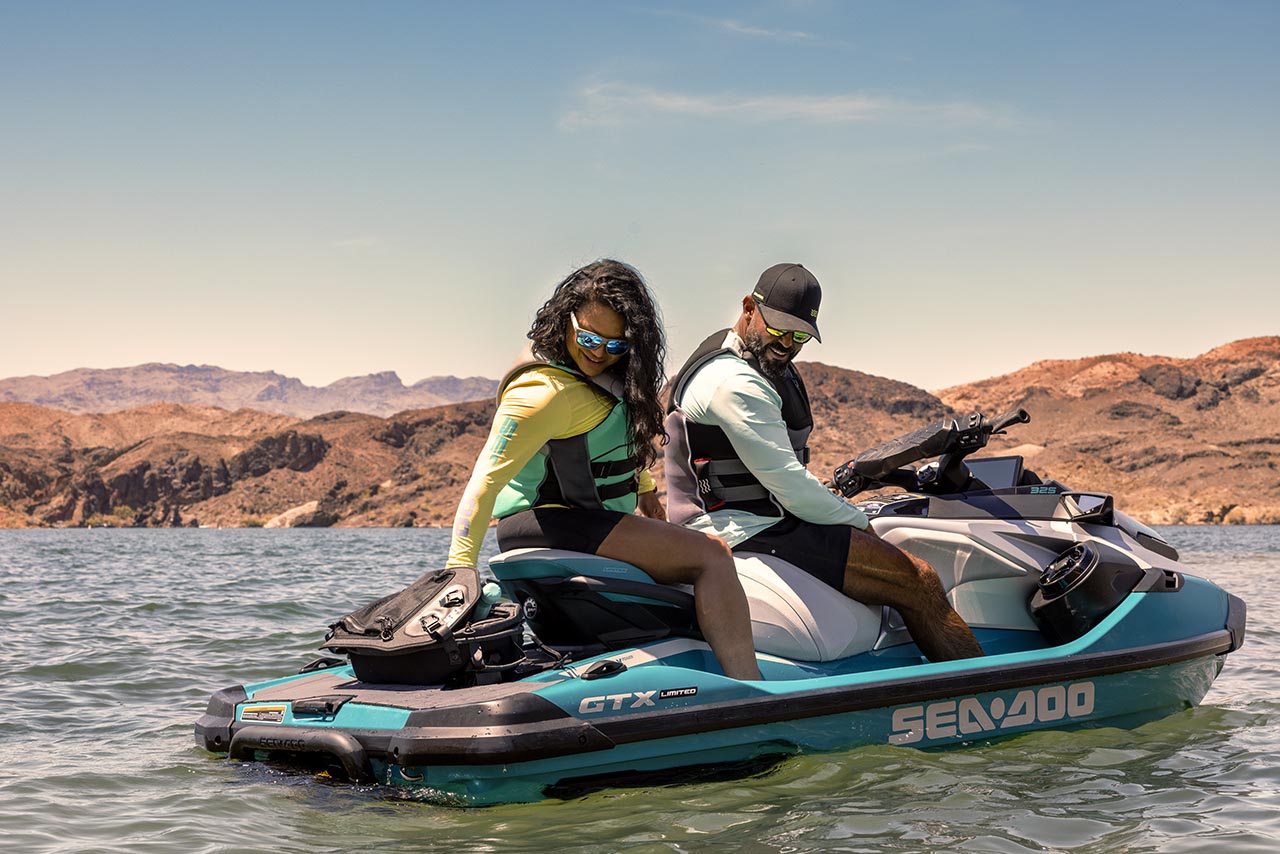 Man and woman sitting on a Sea-Doo GTX Limited personal watercraft
