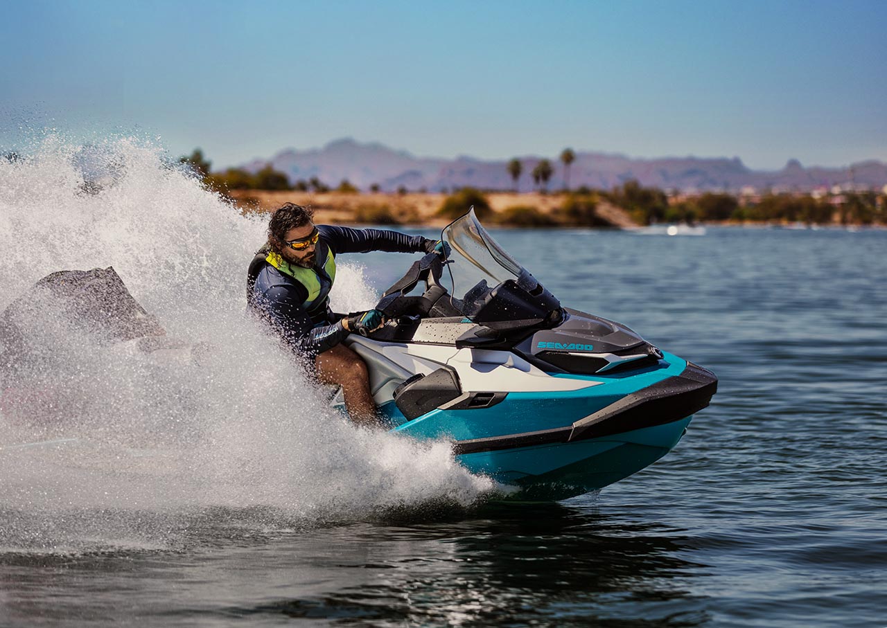 Couple sitting on a Sea-Doo GTX Limited personal watercraft