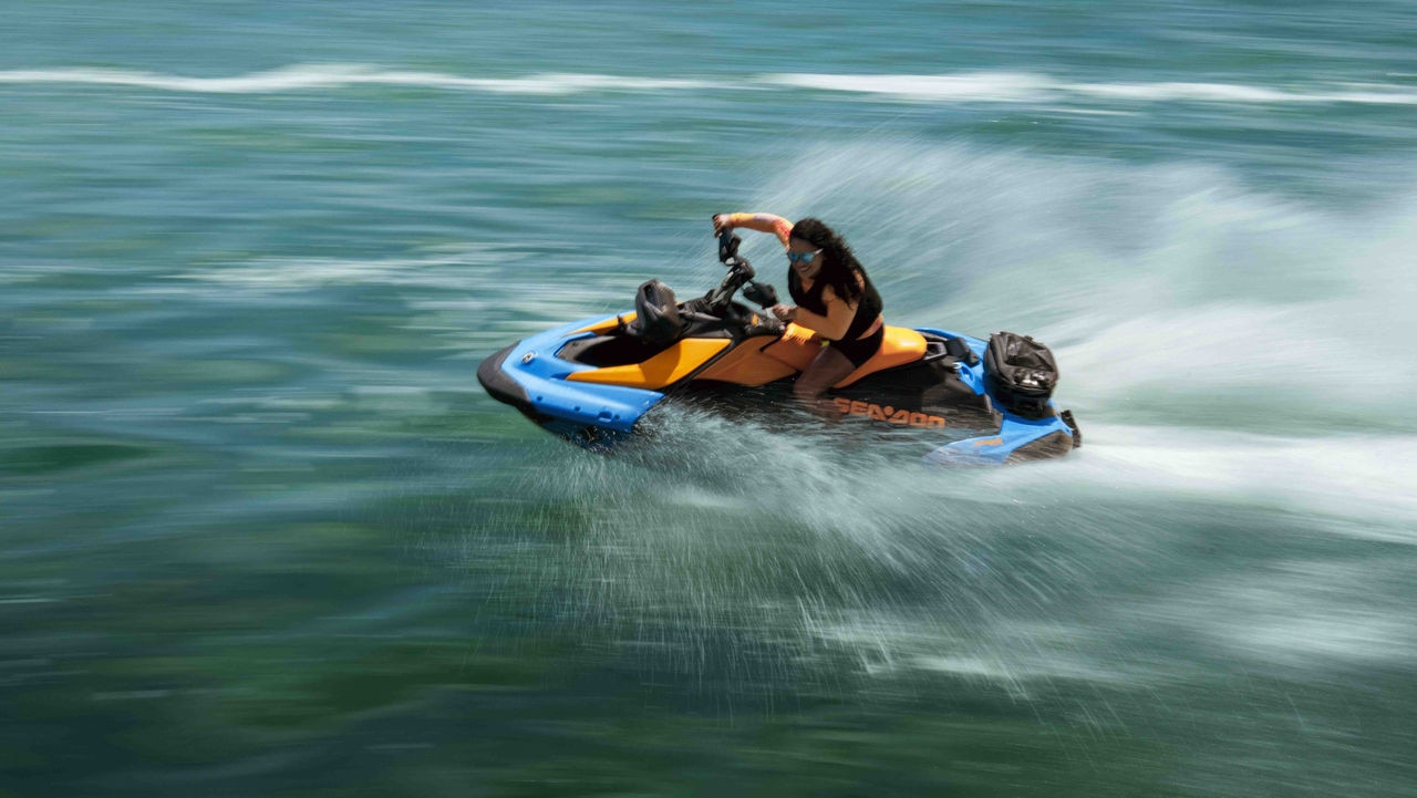 Woman pulling off a trick on a 2025 Sea-Doo Spark Trixx personal watercraft