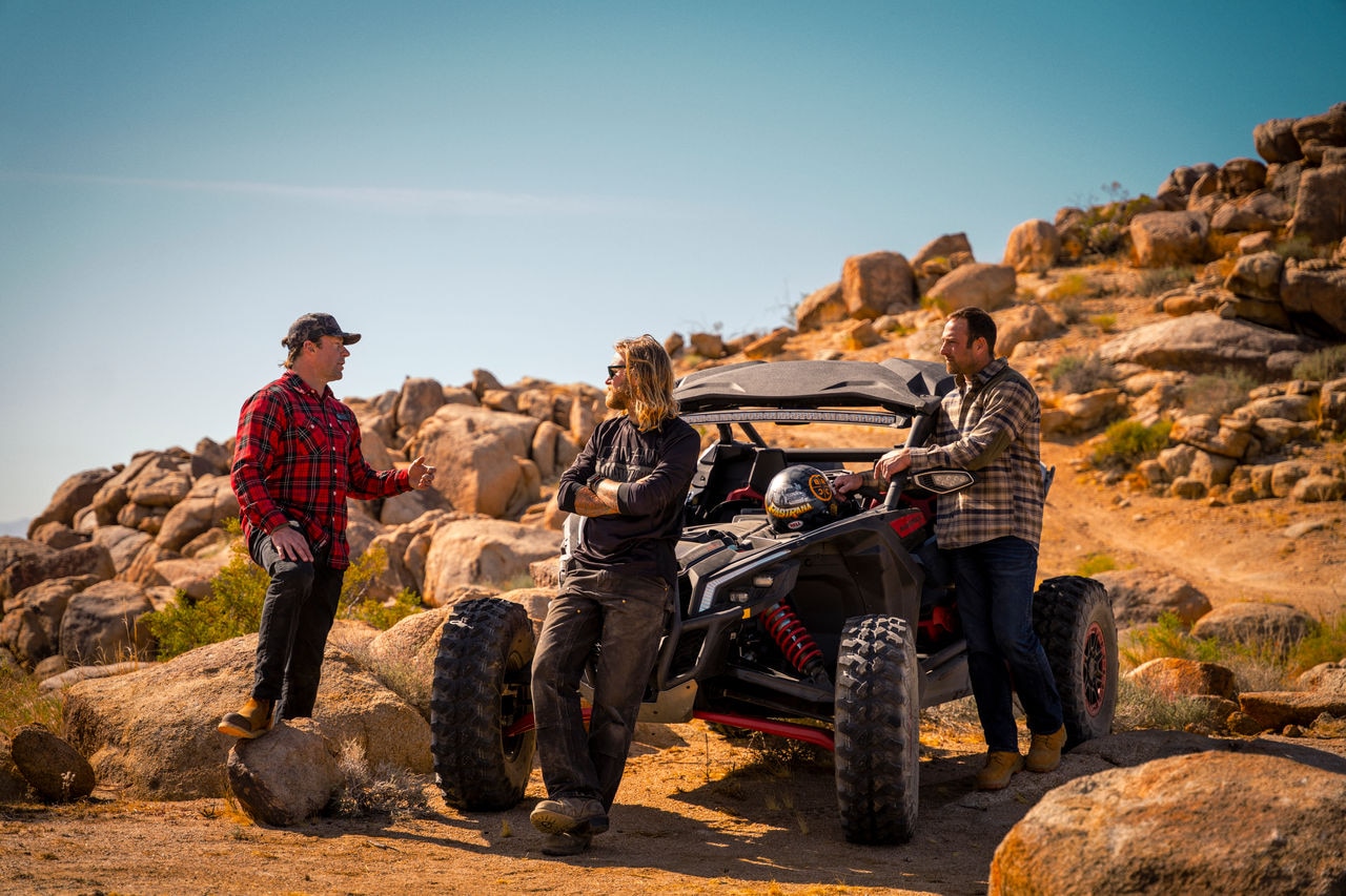Man driving a Can-Am Maverick in the sand
