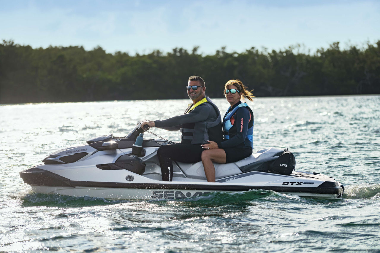 Couple sitting on a Sea-Doo GTX Limited personal watercraft