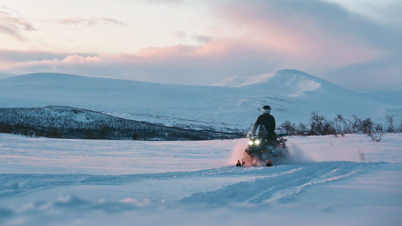 2027 Lynx 59 Ranger snowmobile riding through a snowfield