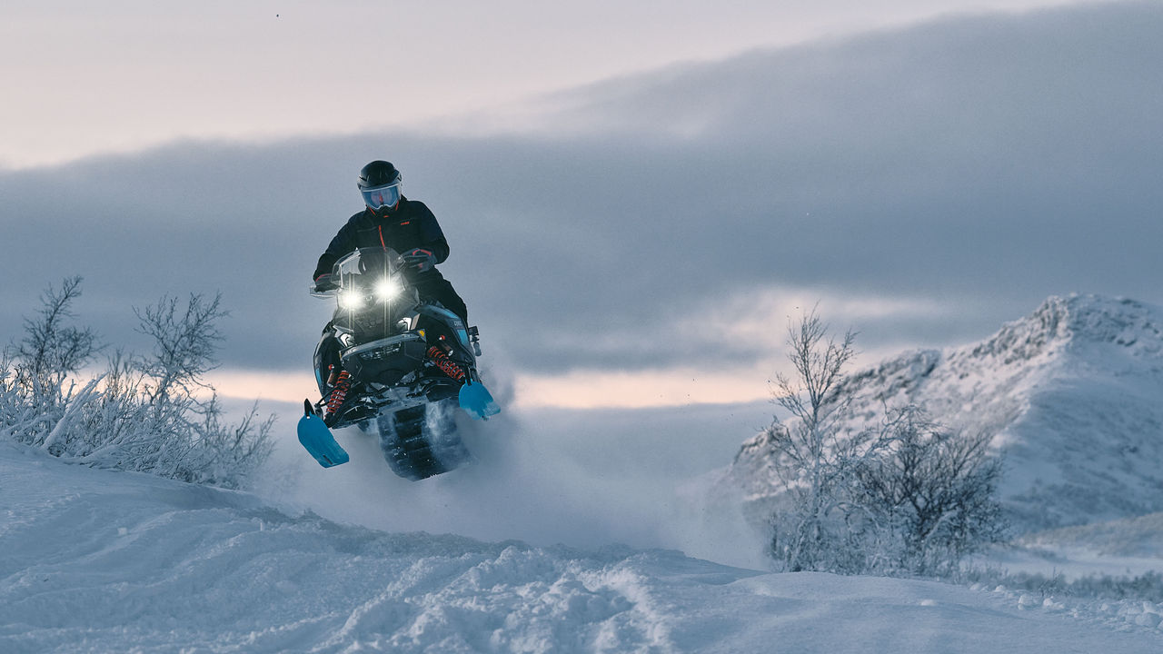 Lynx Commander Limited 2026 snowmobile riding uphill in deep snow