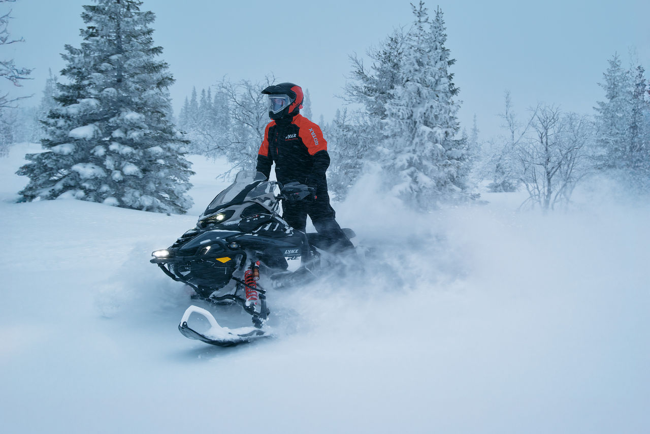 Rider riding standing up on a 2027 Commander RE snowmobile