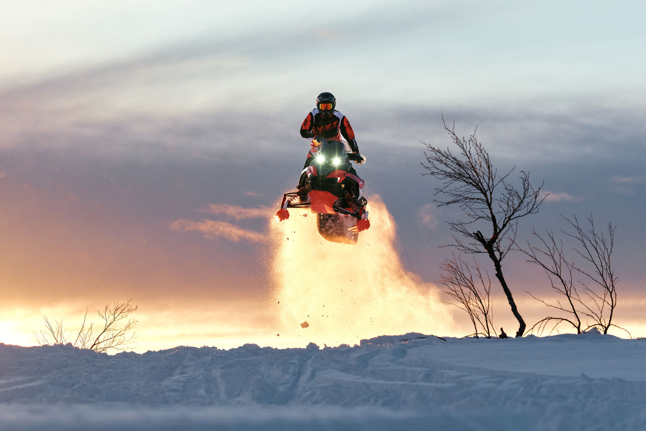 Rider performing a jump on a 2027 Lynx Rave RE snowmobile 