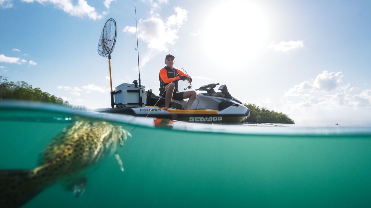 Men catching a fish on a Sea-Doo FISH PRO