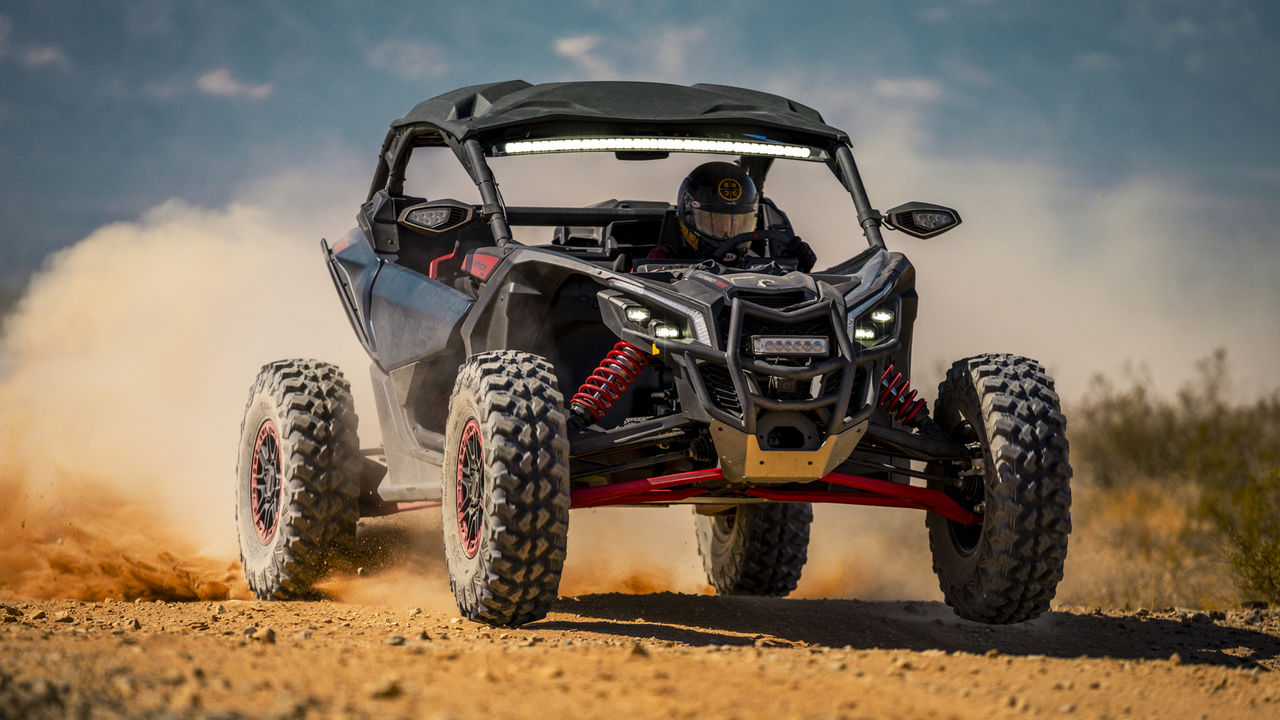 Man driving a Can-Am Maverick in the sand