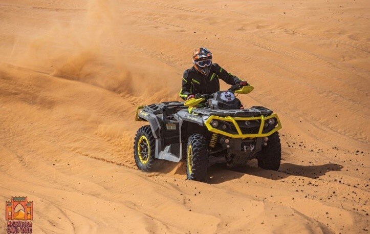 man riding Can-Am outlander in  Morocco dunes