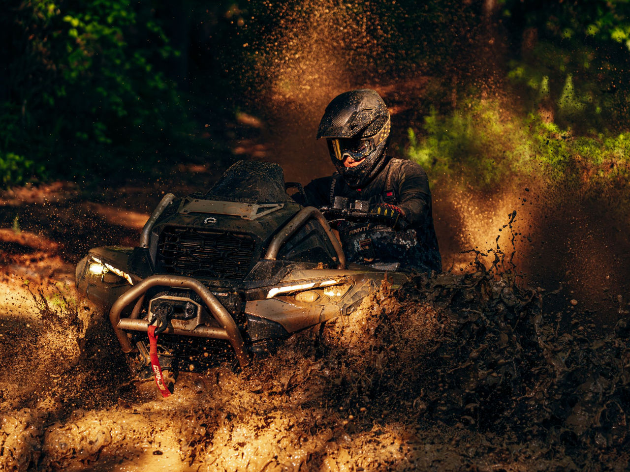 Rider riding in deep mud with a 2027 Can-Am Outlander ATV