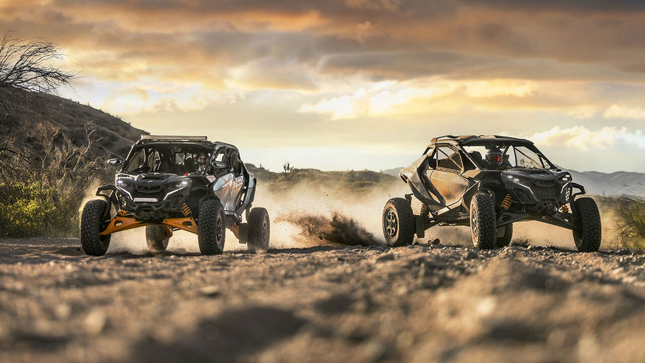 Two 2027 Can-Am Maverick R SxS riding in the desert at dawn