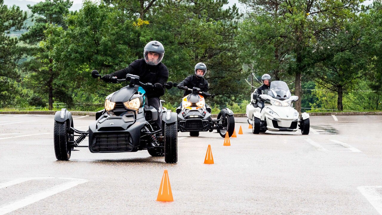 Several people taking their Can-Am 3-wheel motorcycle driving test