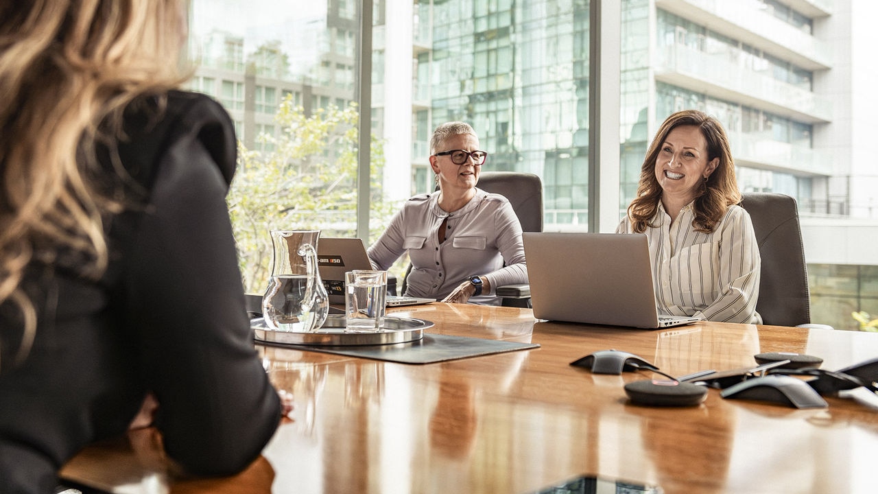 Three BRP employees discussing around a table