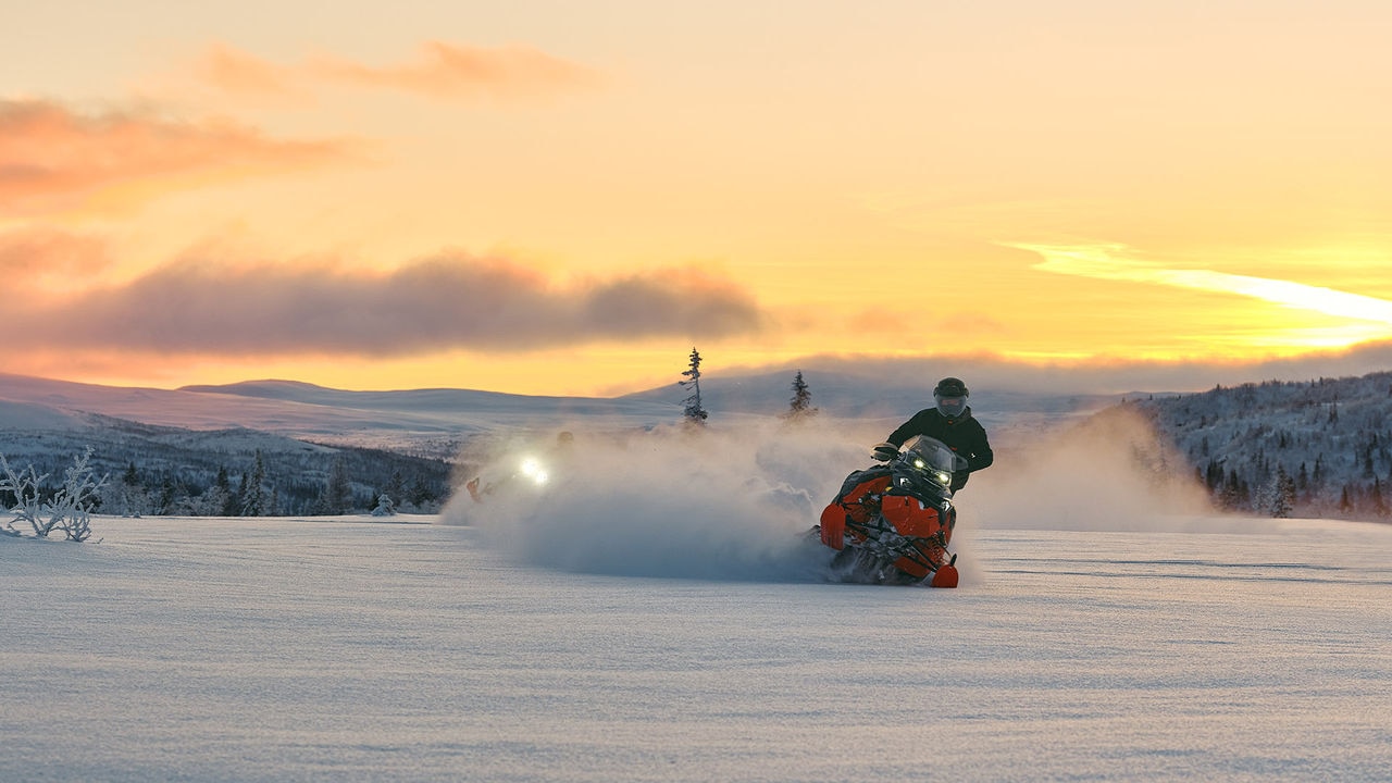 Ski-Doo snowmobile zig-zagging on a snowy path