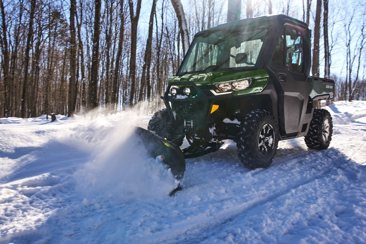 Traxter plowing a snow