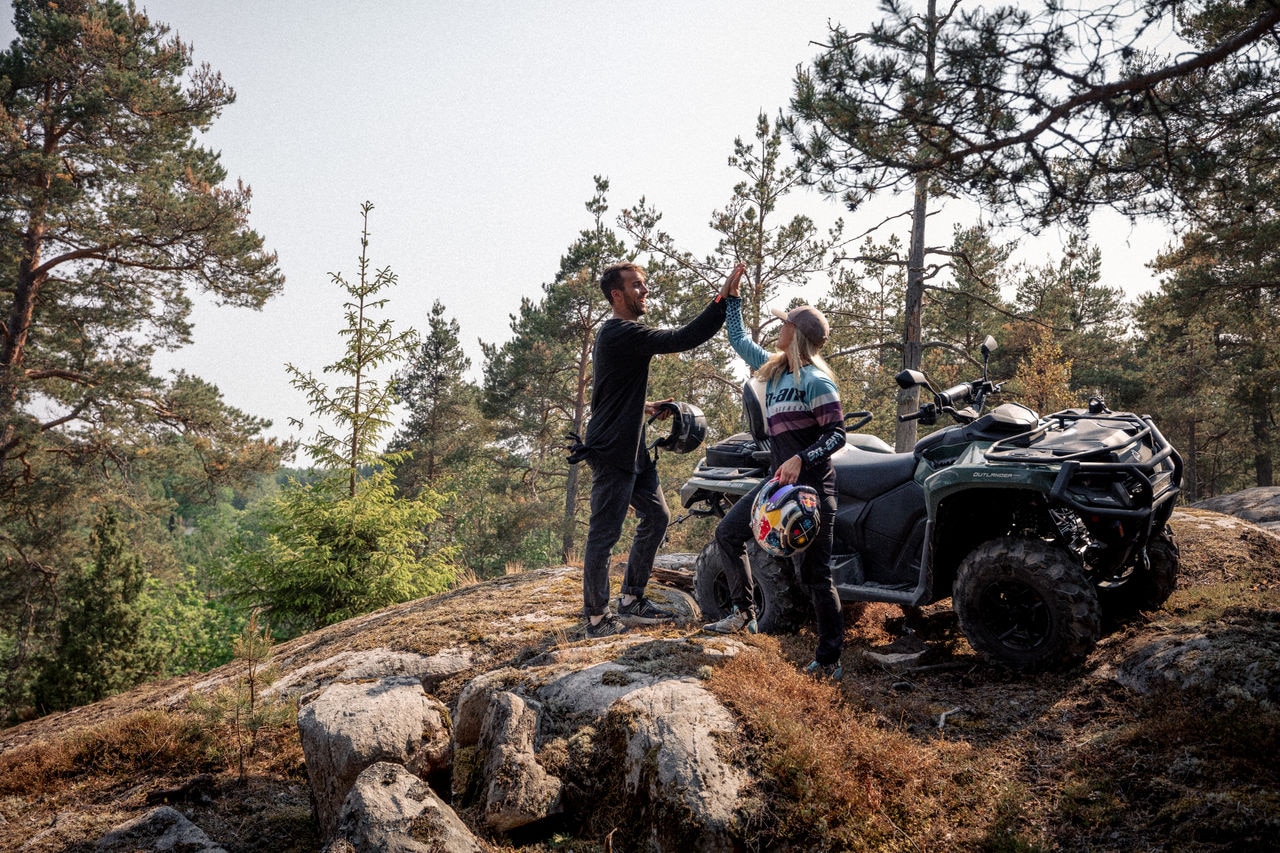 A couple next to an Outlander Max Pro XU HD7 in the mountains