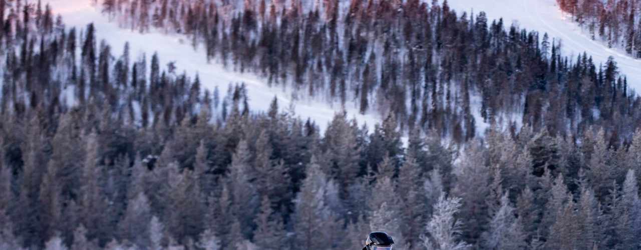 A man is driving his 2021 Lynx Xtrim Model on a snowy road